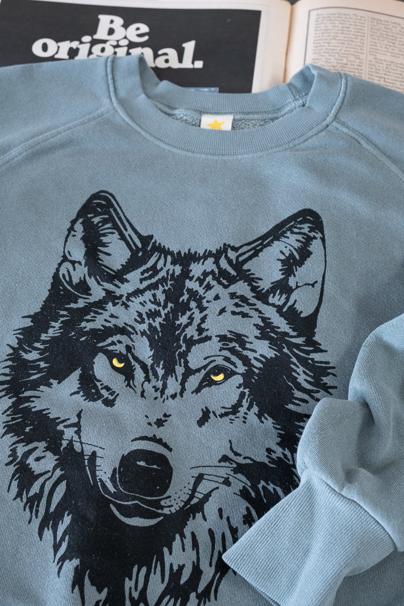 the "mother wolf" vintage wash sweatshirt on green