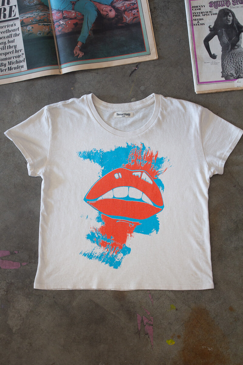 the "she says" graphic tee on white