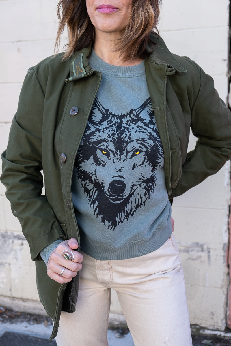 the "mother wolf" vintage wash sweatshirt on green