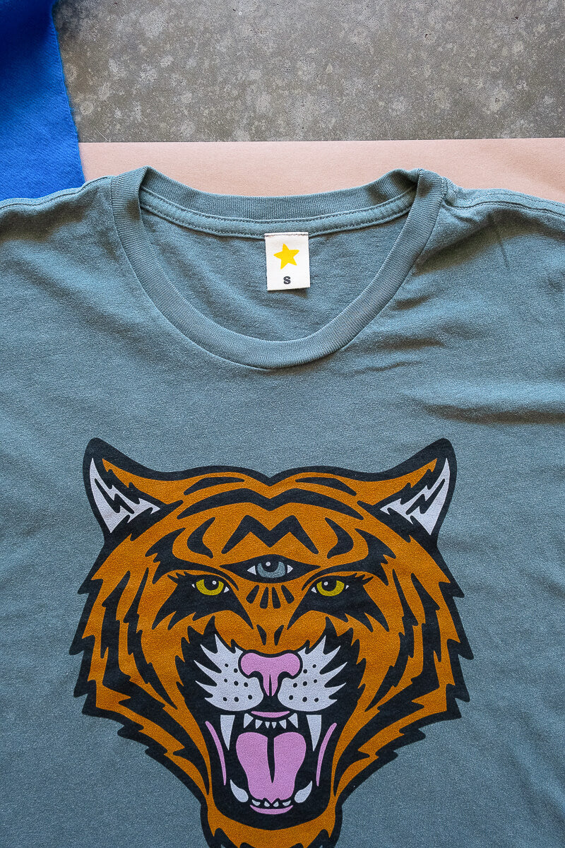 the "cosmic tiger" graphic tee on vintage green