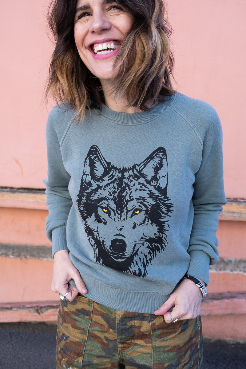 the "mother wolf" vintage wash sweatshirt on green